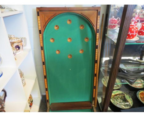 A large cased bagatelle game with a set of balls and two cues 