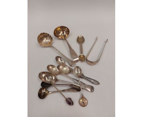 A quantity of silver cutlery items including sauce ladle of shell form and sugar tongs 