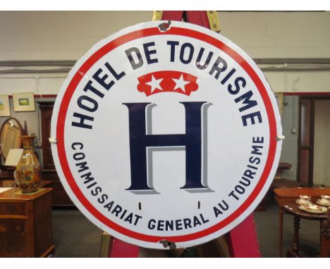 A vintage enamel "Hotel de Tourisme" sign, 40cm diameter 