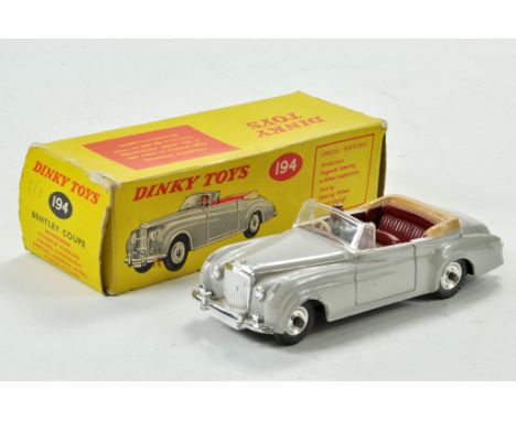 Dinky No. 194 Bentley Coupe in light grey, maroon interior, fawn hood and chrome spun wheels plus driver figure. Generally ve