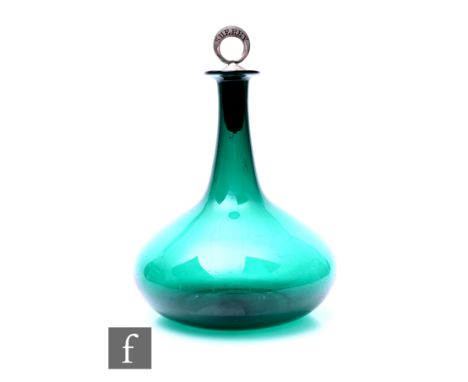 A 19th Century ships decanter of low shouldered form with a tall slender neck and flared rim in deep green, fitted with a whi
