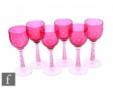 A set of six early 20th Century wine glasses, each with a large ovoid ruby glass bowl, engraved with a Jacobite rose and 'rev