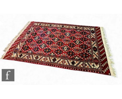 A large Chodor carpet, probably early 20th Century, soft pile with Chodor gul design, with Yomud edging and one deliberate do