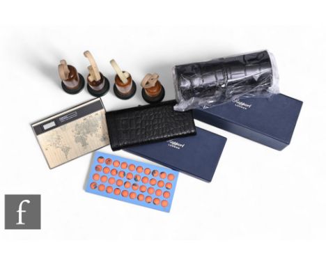 A set of four Chrono Swiss watch stands, a Kienzle world time alarm clock, a Breitling puzzle and two Rapport watch travel ca