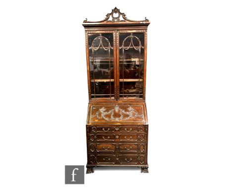 A late 19th to early 20th Century Chippendale Revival mahogany bureau bookcase, with pierced scroll pediment over bar glazed 
