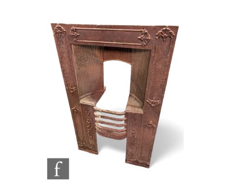 A Victorian cast iron bedroom fire place with small grate flanked by floral panel sides, 95cm x 58cm.