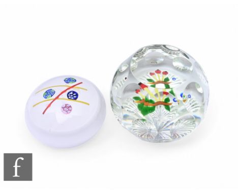 A later 20th Century clear crystal glass paperweight, internally decorated with lampwork flowers and foliage, the dome cut wi