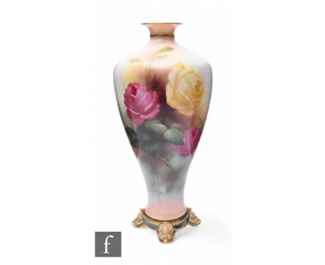 C V White for Royal Worcester, a rose painted vase, shouldered form, on circular base with four foliate moulded feet, decorat