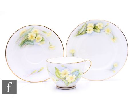 Daisy Rea for Royal Worcester, a floral painted trio, circa 1955, decorated with yellow primroses over washed blue/grey and i