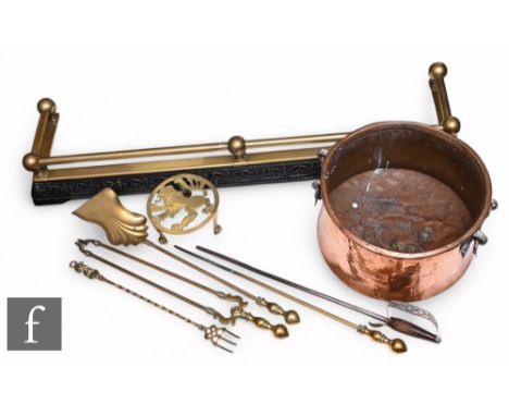 A Victorian brass rail and cast iron fender, length 117cm, a set of three brass fire irons, a toasting fork, a poker a brass 