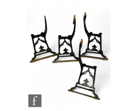 Two pairs of cast iron bench ends in the manner of Christopher Dresser, with Wake &amp; Dean London foundry stamps to the fra