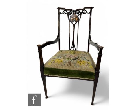 An Edwardian inlaid mahogany elbow chair, the pierced vase splat with copper and pewter detail, down swept arms on square tap