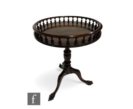 A George III style mahogany circular gallery tripod table on carved legs terminating in claw feet, diameter 46cm.