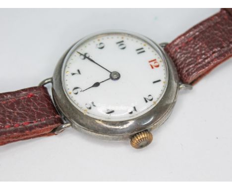 An early 20th century silver Elem Watch Co. trench style wristwatch having unsigned enamel dial with Arabic numerals, spade h