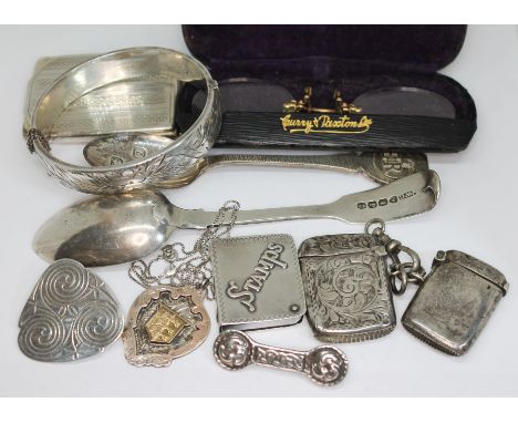 Assorted hallmarked silver and white metal comprising a bangle, two spoons, two vesta cases, a match book, a medal, a Celtic 