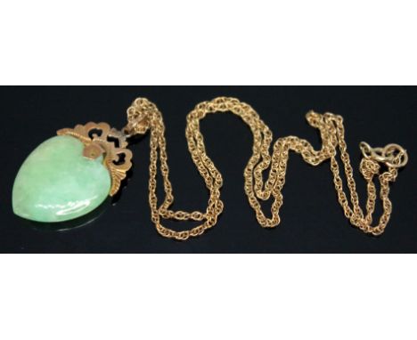 A heart shaped jadeite jade pendant with mount marked '585', length 34mm, on 46cm chain marked '9K', gross weight 6.34g.  Con