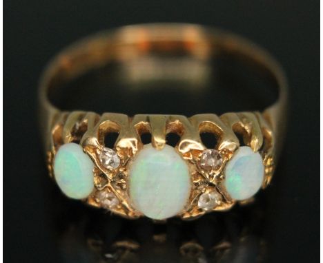 A precious opal and diamond ring, hallmarked 18ct gold band, gross wt. 2.67g, size P.  Condition - slight abrasions to caboch