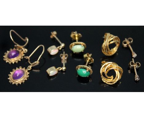 Three pairs of hallmarked 9ct gold earrings comprising a pair set with amethyst cabochons, a pair set with precious opal, a p