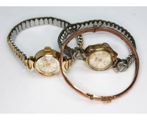 A ladies 9ct gold wristwatch with plated strap, another gold plated wristwatch and a child's yellow metal bangle weight 3.37g