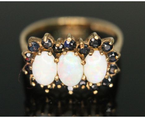 A hallmarked 9ct gold precious opal and sapphire ring, gross weight 2.31g, size M.  