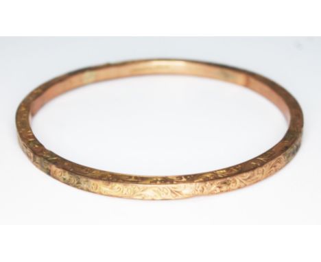 A hallmarked 9ct gold bangle, diam. 7.5cm, weight 9.62g.  Condition - various holes and dings...