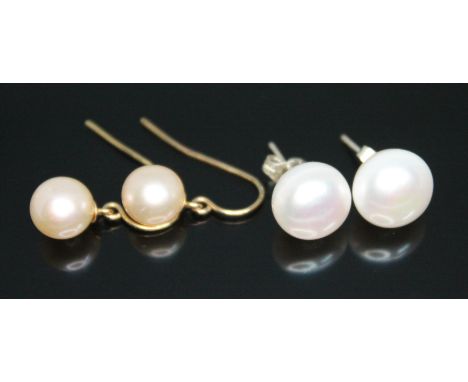 Two pairs of cultured pearl earrings, one with hooks marked '14K', diameter of pearls approx. 9mm, the other pair with button
