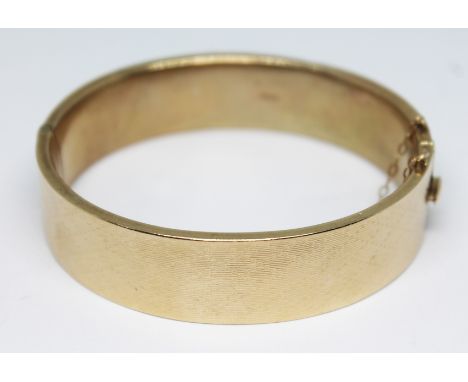 A hallmarked 9ct gold bangle engraved with diamond design, sponsor's mark 'M, G&amp;S', Chester 1935, diam. 58mm, weight 24.2