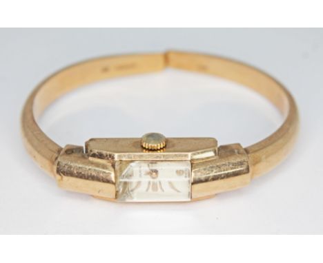 A vintage hallmarked 9ct gold Olma ladies manual wind bangle wristwatch, the inside case back and bangle hallmarked London 19