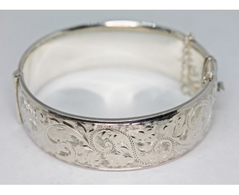 A bright cut engraved silver bangle, diam. approx. 58mm, weight 45.13g  Condition - good, general wear including minor marks 