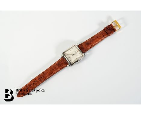 E. Gubelin Lucerne stainless steel wrist watch. The watch having a 30mm case with a white webbed face with both button and ba