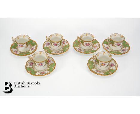 Six Coalport demitasse and saucers, green batwing pattern V 2665, featuring floral sprays in gilt reserves.&nbsp;

Condition 