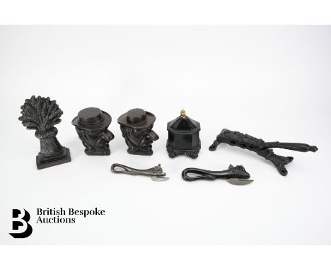 A near pair of cast iron tobacco jars, 12.5 cms h, a segmented tobacco jar and cover, 13 cms h with acorn finial, a table cas