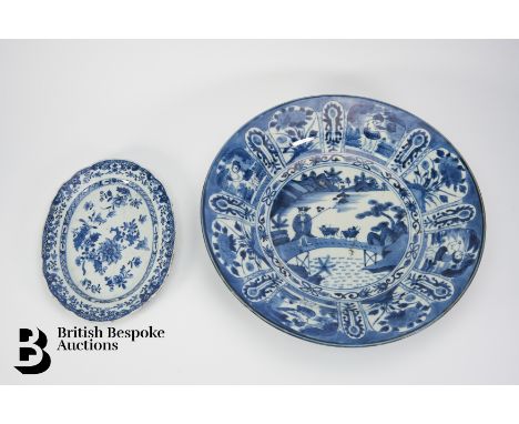A Chinese export blue and white deep dish, with a central scene depicting a lone figure herding water buffalo, enclosed by al