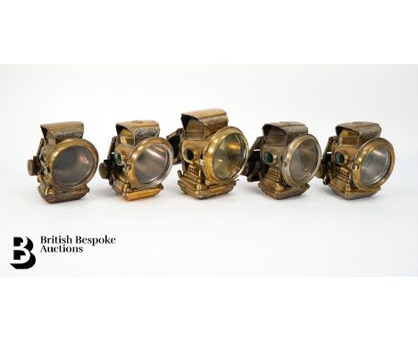 Five brass Joseph Lucas oil bicycle lamps, including a Lucas Holophote approx 14 cms h, and four Joseph Lucas SilverKing oil 