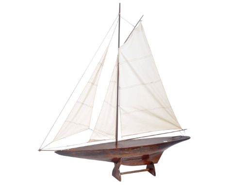 A large 5.5ft early 20th Century scratchbuilt hand made model boat having a large two part central mast with four section sai