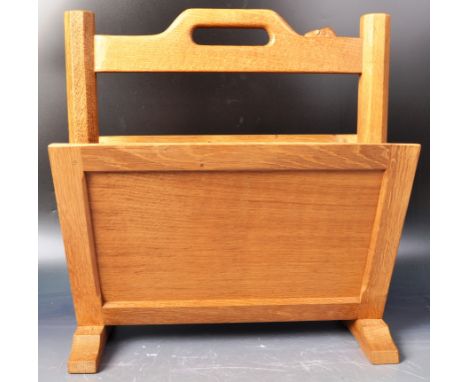 A Robert 'Mouseman' Thompson oak magazine rack. Solid oak magazine rack featuring sloping panelled sides for magazine storage