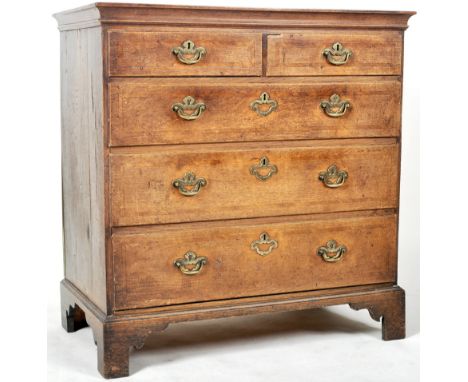 An 18th Century George III walnut chest of drawers. The bank of two over three graduating drawers with each having brass swin