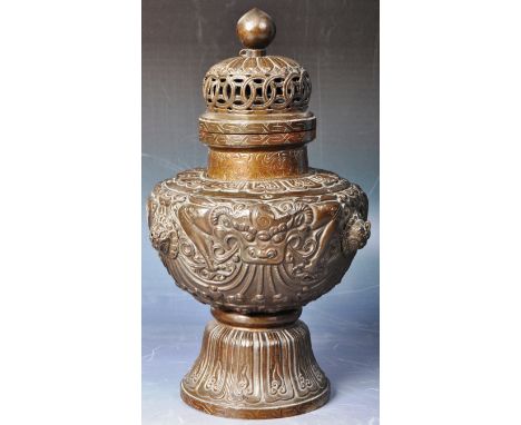 A 19th Century Chinese Tibetan copper repousse decorated altar vase / censer burner having a pierced finial lid with the urn 