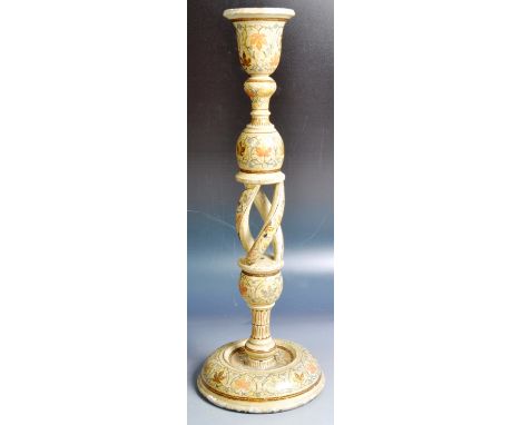 A 19th Century Persian Kashmir wooden single candlestick having a shaped bell candle sconce with bluster section above an ope