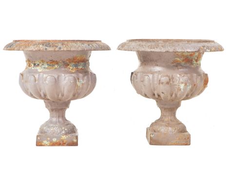 A pair of 19th Century cast iron campagna garden urns in the manner of Coalbrookdale. Each urn with folded rim, relief decora