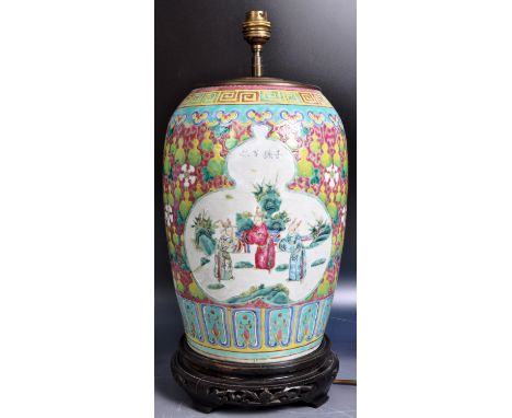 A 19th Century Chinese porcelain vase of barrel shape having hand painted famille rose decoration with white cartouche panels