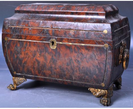 An early 19th Century Regency period Amboyna Burl Wood tea caddy of sarcophagus shape having a hinged lid opening to reveal a