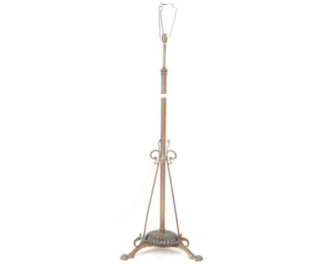 An early 20th Century Art Nouveau brass and copper converted free standing standard lamp light having a single brass column c