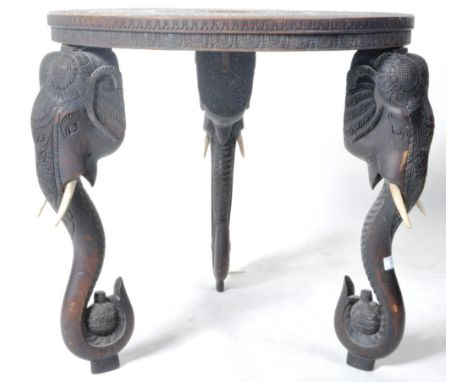 A late 19th Century Indian carved hardwood occasional / tea table having a circular top with carved patterned detailing and c