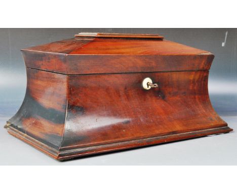 An early 19th Century Regency period mahogany tea caddy box of sarcophagus shape having a stepped lid with shaped body and pl