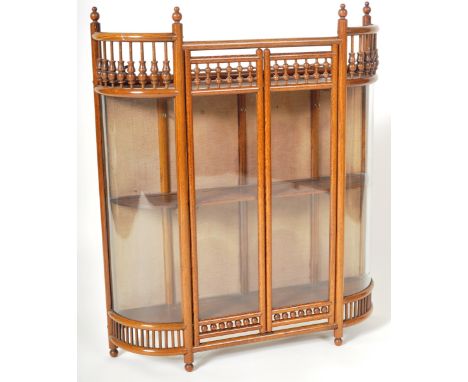 A late 19th Century French elm and glass hanging shop display cabinet vitrine of Chinese influence having decorative bobbin f