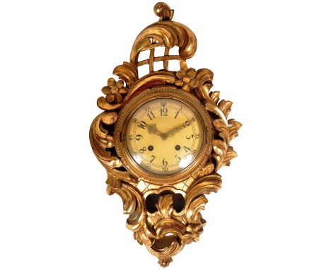 A 19th Century French carved cartel wall clock with giltwood gesso plaster finish with acanthus leaf and floral frame. Centra
