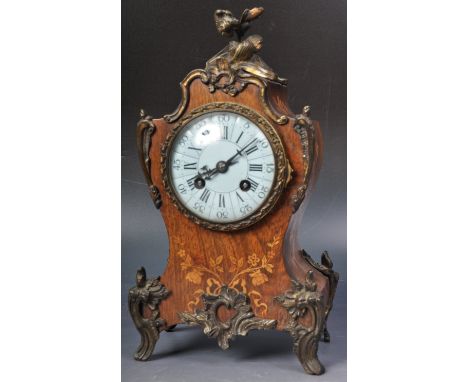 A 19th Century French rosewood mantel / table clock having applied brass mounts of floral and scrolled form with detailed inl
