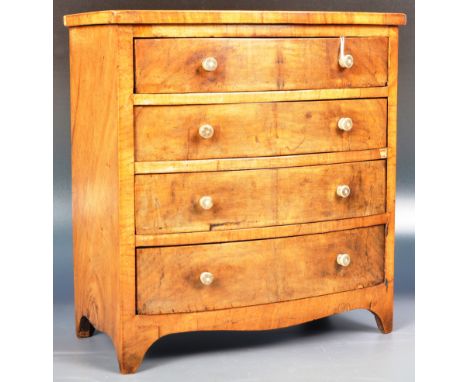 An early 19th Century George III walnut salesman sample apprentice piece miniature chest of drawers. The bow fronted bank of 