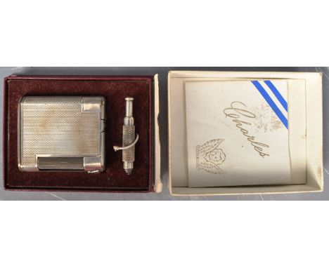 An early 20th Century The Charles silver plated lighter. The lighter having an engine turned body with twin light up sections